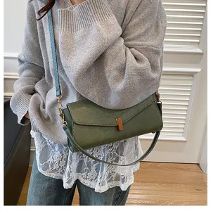 Chic retro green shoulder bag detail, stylish crossbody design with metal lock and strap.