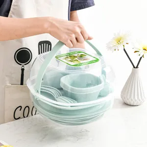 Tragbares 54-teiliges Camping-Picnic-Geschirrset mit transparenter Kuppel und grünen Tellern.