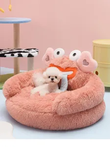 Detailed view of the plush pink pet bed with cute monster design and cozy furry interior.