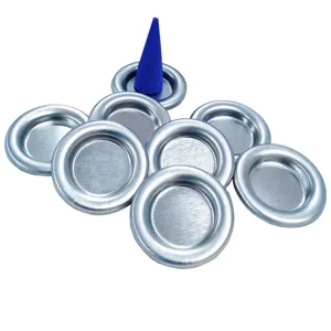 Detail view of small metal incense trays and a blue cone incense showing fine texture.
