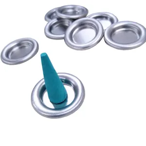 Close-up detail of silver metal incense tray with teal cone incense burner for aromatherapy.