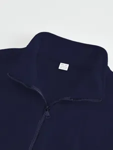 Dark navy blue stand collar jacket detail shot, featuring zipper and soft polyester fabric.