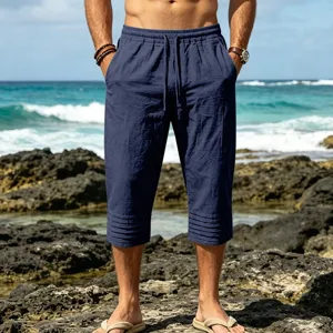 Detailed view of men's casual drawstring navy blue pleated capri shorts for summer beach.