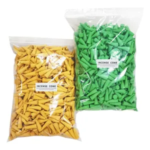 Detailed shot of bulk colorful incense cones in transparent bags, green and yellow.