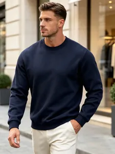 Close-up view of the casual solid navy blue crewneck sweatshirt worn by the model.