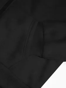 Black zipper hoodie detail shot, comfortable ribbed cuffs and front pocket, casual sports style.