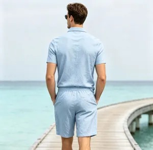 Detailed view of men linen short sleeve polo shirt and matching shorts set in outdoor scene.