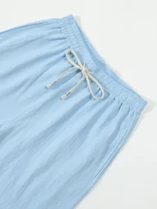 Light blue casual shorts detail showcasing elastic drawstring waistband and textured fabric.