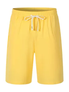 Detailed view of casual yellow men's shorts with comfortable elastic drawstring waistband.