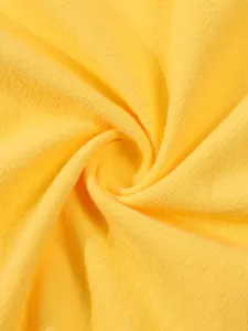 Detailed view of bright yellow cotton linen fabric for men's casual long sleeve shirt.