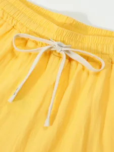 Close-up detail of casual shorts waistband with adjustable drawstring. Premium cotton blend fabric.