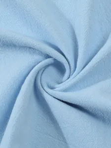 Light blue linen cotton fabric detail shot, premium solid color shirt material close up.