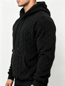 Close-up detail of the black fleece textured hooded sweatshirt showcasing fabric and knit pattern.