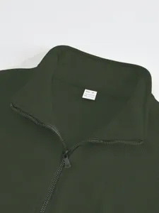 Dark green stand collar half zip jacket detail shot, premium polyester fabric close-up view.