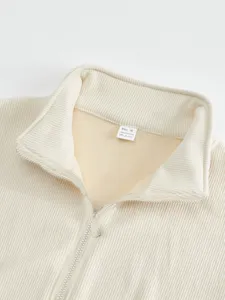 Close-up detail of mens fleece lined corduroy zip up jacket collar and metal zipper.
