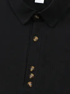 Close-up detail of men's black cotton linen shirt collar, tortoiseshell buttons, texture.