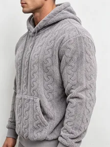 Detail view of men's grey fleece teddy velvet hoodie, textured cable knit design with cozy pocket.