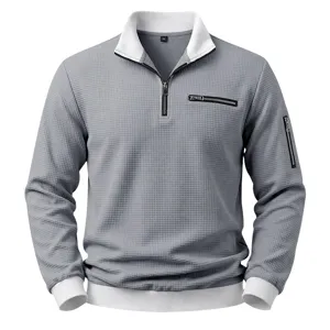 Detail view of men waffle knit 1/4 zip mock neck sweatshirt in grey with contrast white collar.
