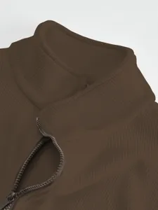 Men's heavy mock neck fleece jacket detail, brown ribbed fabric texture close up view.