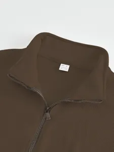 Men's brown ribbed stand-up collar quarter-zip jacket detail view, casual outerwear.