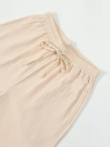 Detailed view of men's casual trousers elastic waistband with drawstring, soft texture.