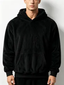 Close-up details of the black fleece hoodie, soft coral velvet texture, cozy winter wear.