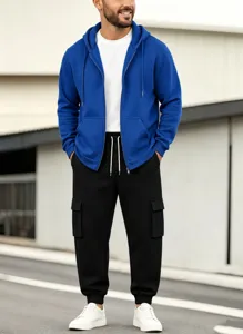 Men's casual royal blue zip hoodie and black cargo joggers set outdoors modern view.