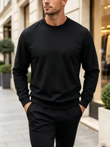 Men's solid black crewneck sweatshirt detail view showcasing casual minimalist style.