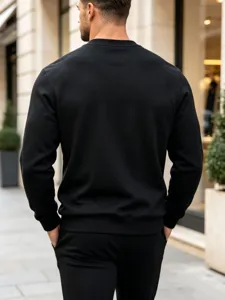 Detail view of men's casual black crewneck sweatshirt featuring a clean solid design.