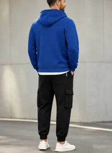 Back view of mens fleece hooded sweatshirt and black cargo pants set for winter daily wear.