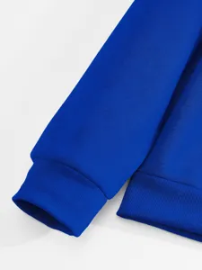 Close-up detail shot of the royal blue sweatshirt sleeve cuff and hem, showcasing fine texture.