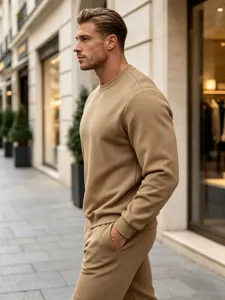 Detail shot of men casual solid camel crewneck sweatshirt and sweatpants set in street style.
