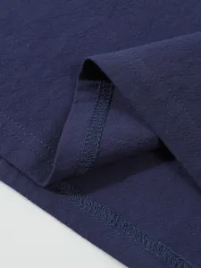 Close-up detail of dark blue cotton linen shirt fabric texture and fine stitching craftsmanship.