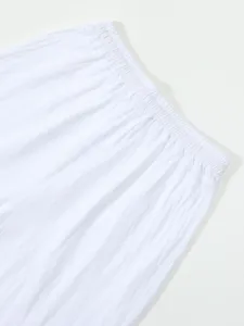White casual shorts elastic waistband detail view, showing soft linen fabric texture.
