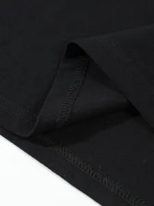 Close-up detail of black fabric hem and stitching, fine texture, high-quality garment workmanship.