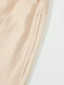 Men's casual linen shorts pocket detail close-up, breathable lightweight summer fabric.