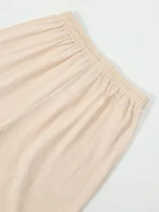 Close-up detail of men's casual linen shorts elastic waistband, breathable summer fabric.