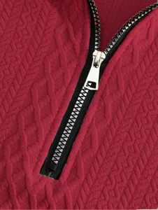 Detailed close-up of a red textured jacquard fabric featuring a durable metal zipper.