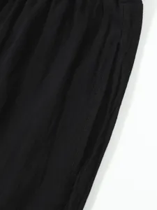 Detail view of mens casual summer shorts side pocket black linen blend fabric clothing.