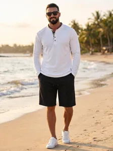 Close-up detail of casual waffle knit long sleeve henley shirt and shorts beach scene outfit.