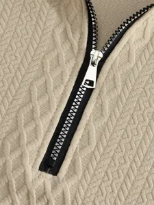 Detailed view of textured jacquard fabric and metal zipper for mens casual outdoor apparel.