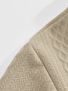 Detailed view of men's casual jacquard fabric with elegant geometric pattern and soft texture.