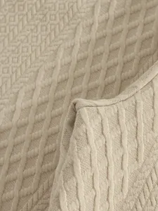 Premium khaki jacquard fabric detail showing intricate geometric texture and soft knit finish.