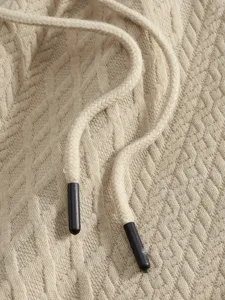 Detailed view of men's casual suit fabric featuring jacquard texture and drawstring.