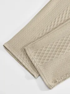 Close-up detail shot of men's casual jacquard fabric showing fine textured pattern.