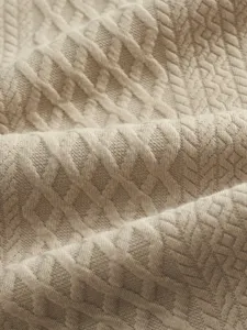 Close-up detail of premium khaki jacquard knit fabric showing soft texture and clear pattern.