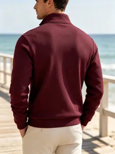 Back view detail of men's maroon stand-up collar quarter-zip sweatshirt outdoor scene.