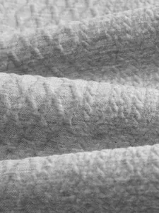 Men luxury jacquard fabric detail shot, premium grey monogram pattern knitwear material.