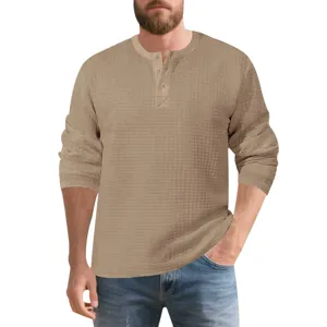 Detailed view of men's waffle knit long sleeve henley shirt with button placket in khaki.