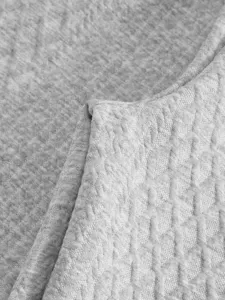 Close-up detail of grey jacquard fabric texture for men casual apparel production.